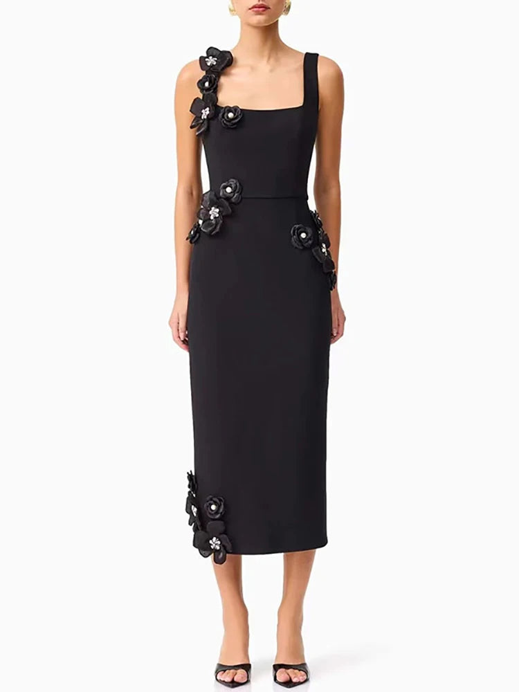 Black dress with floral embellishments on a white background