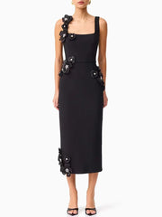 Black dress with floral embellishments on a white background