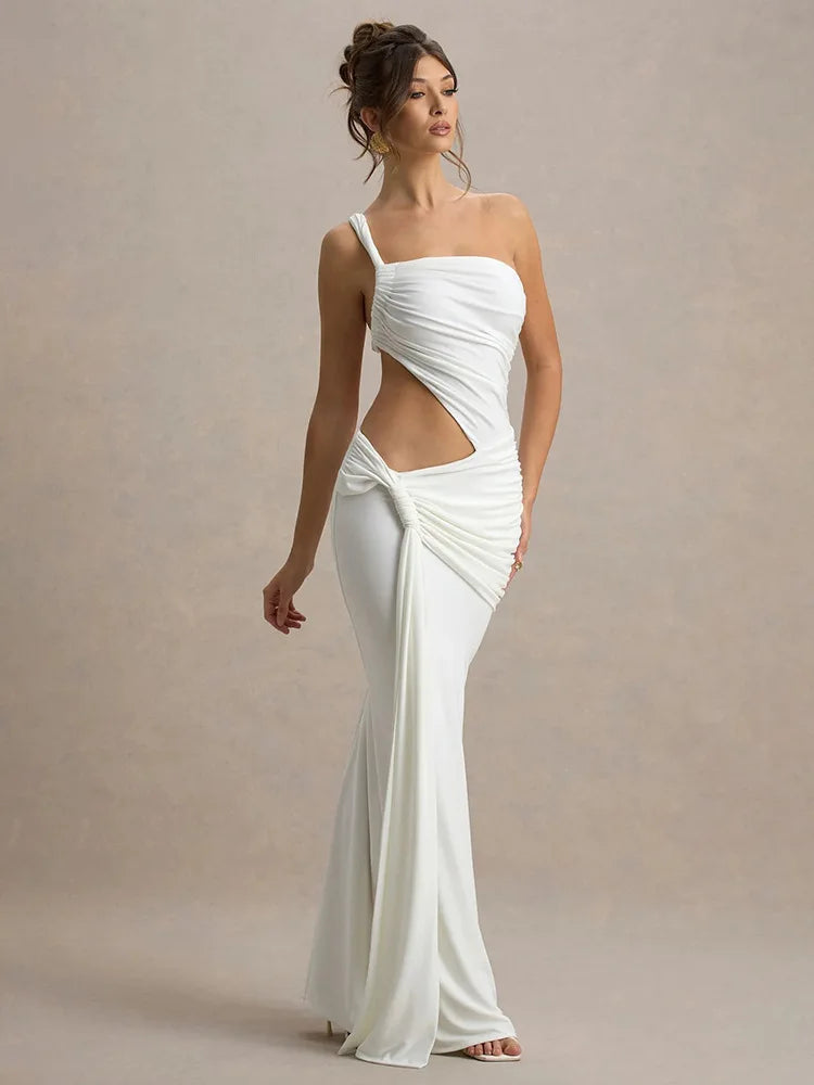 Woman wearing a white one-shoulder gown with a cutout design on a beige background