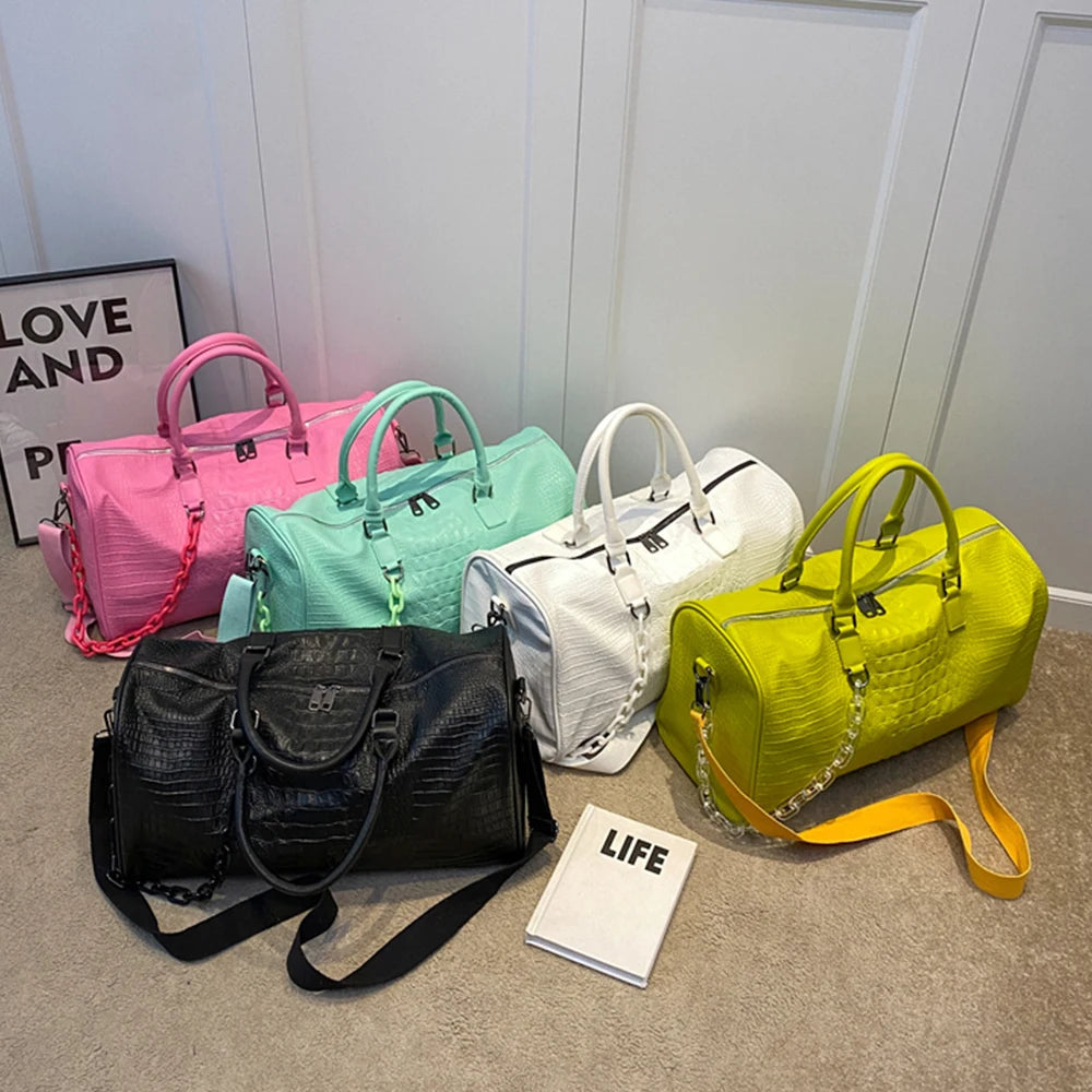 Collection of crocodile embossed travel duffle bags in various colors