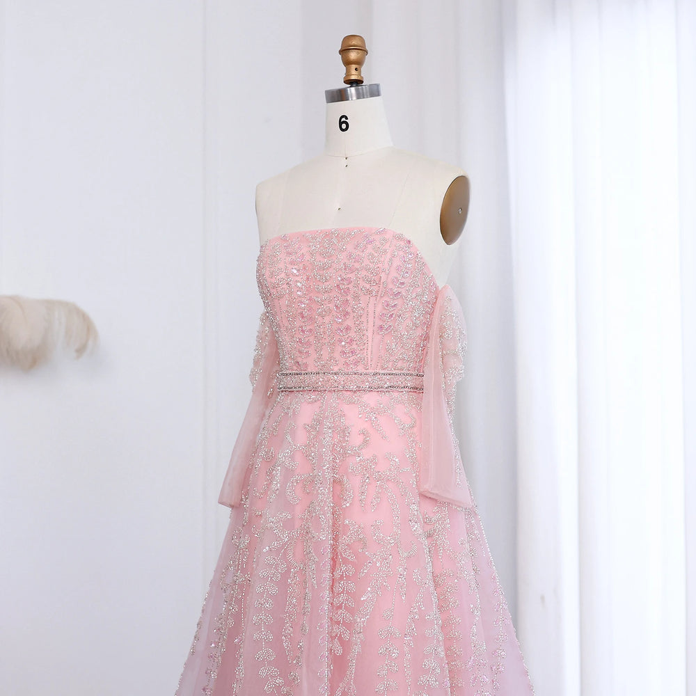 Pink beaded dress on a mannequin against a white background