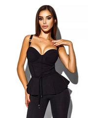 Woman wearing a black peplum top and pants on a white background