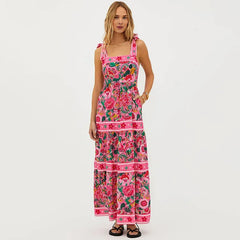 Person wearing a floral print swimwear set with tie shoulder straps and a tiered skirt.