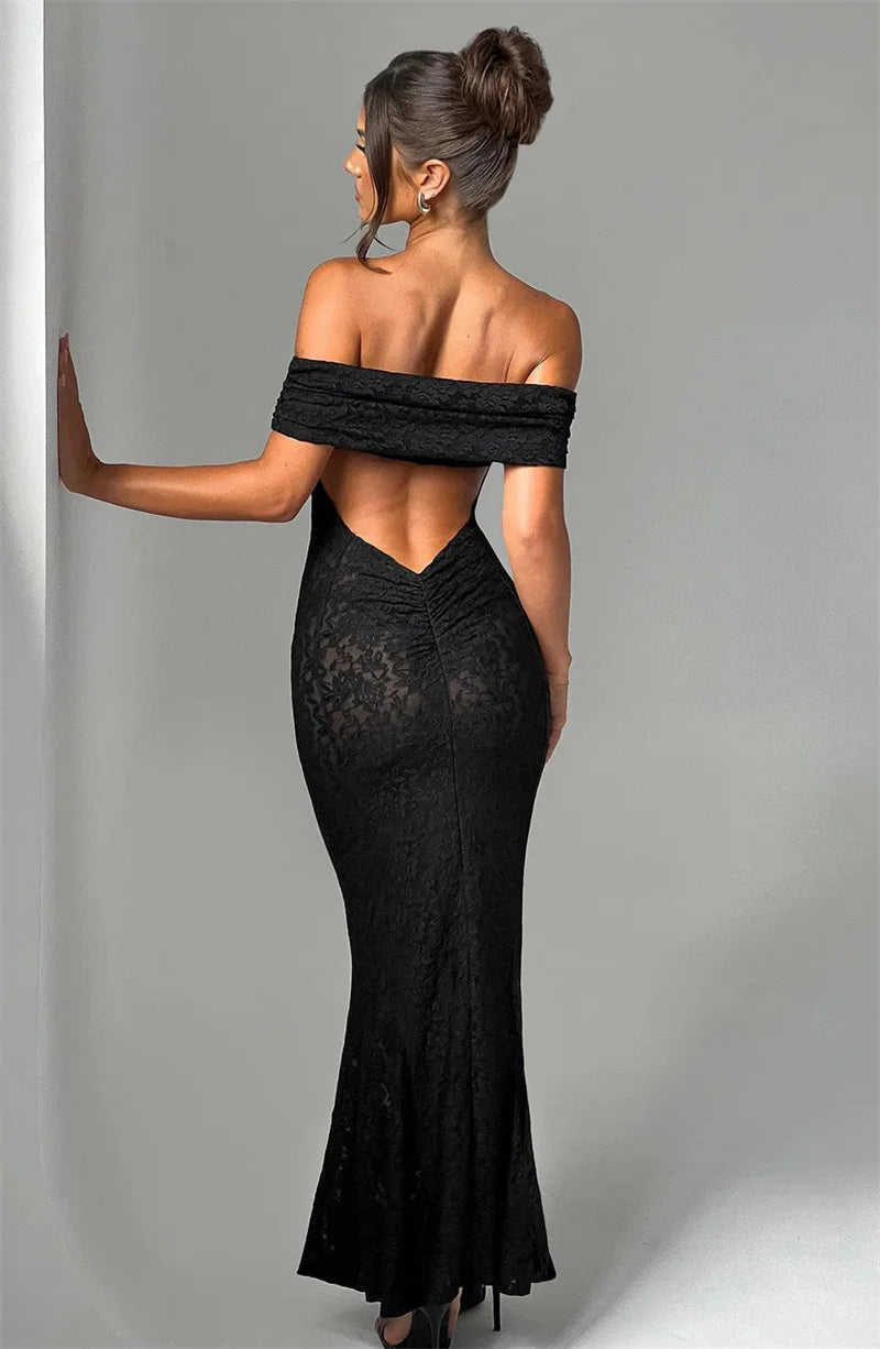 Woman wearing a black off-shoulder evening gown against a gray background