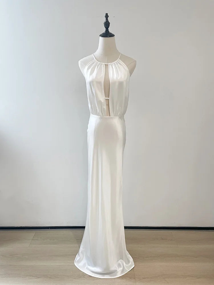 White dress on a mannequin against a plain background