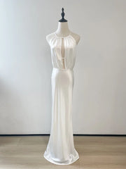 White dress on a mannequin against a plain background