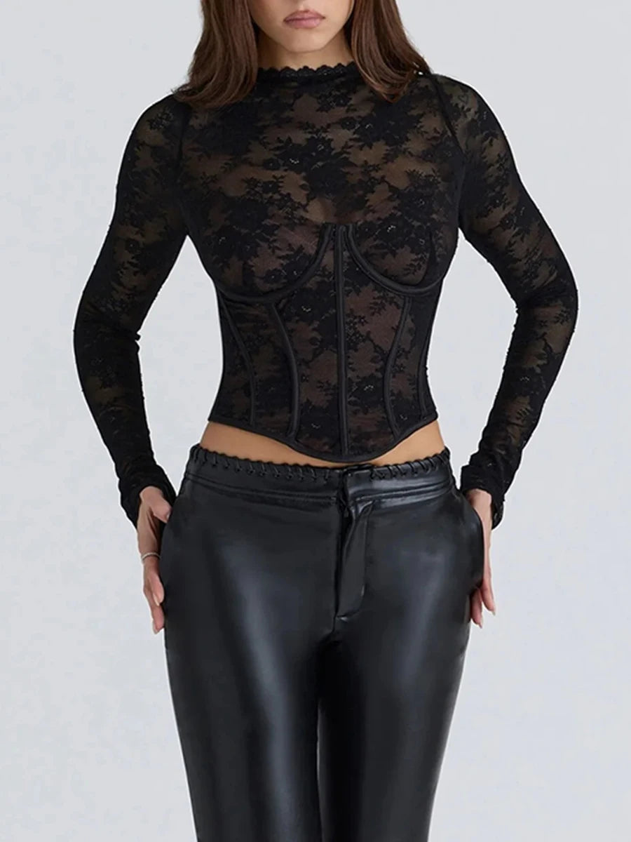 Person wearing a black lace top and black leather pants on a white background