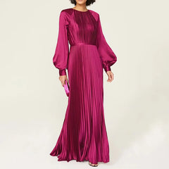 Woman wearing a magenta pleated gown on a white background