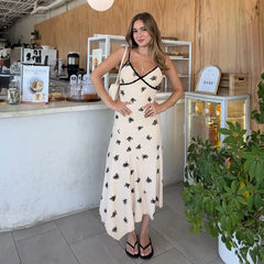 Woman in a floral dress standing in a cafe