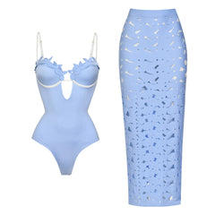 Light blue one-piece swimsuit with floral appliqué neckline and contrast trim, paired with a matching laser-cut maxi skirt.