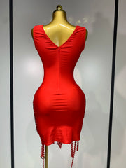 Red dress on a mannequin against a plain background