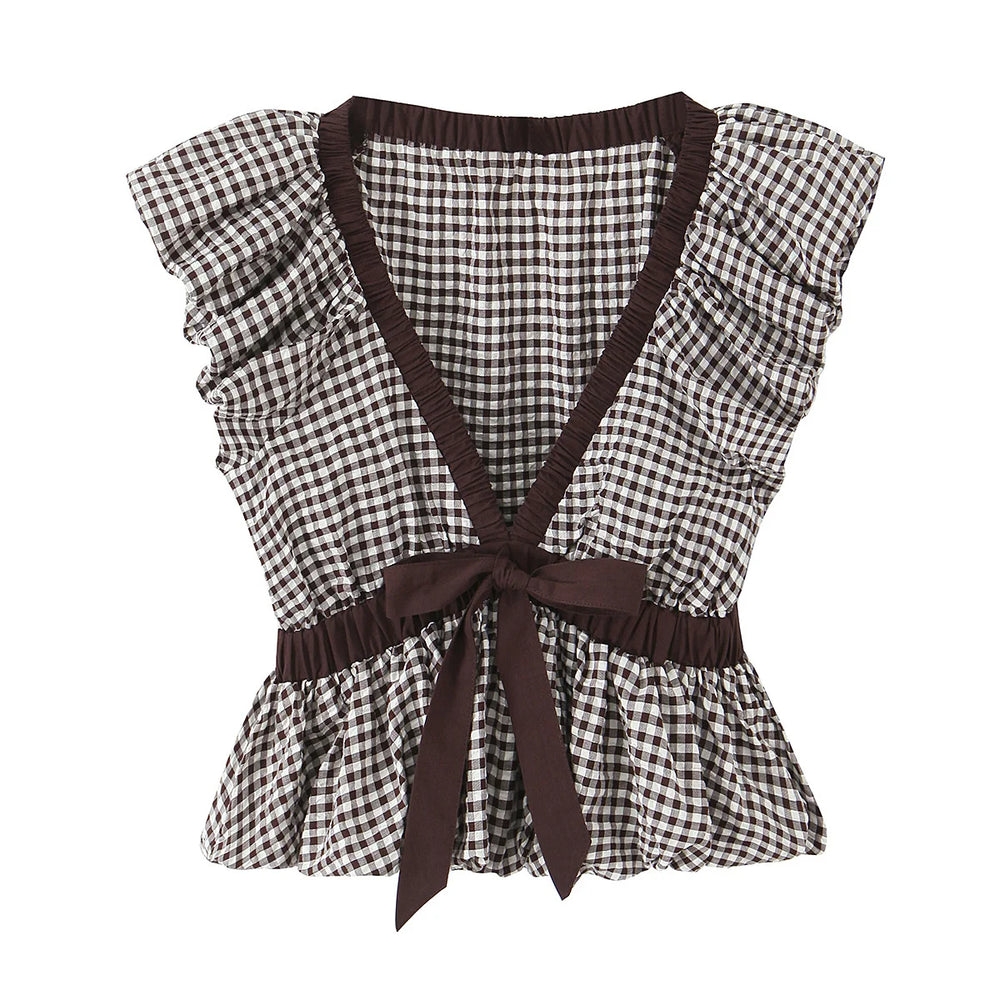 Black and white checkered top with brown straps and trim on a white background