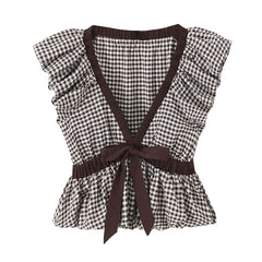 Black and white checkered top with brown straps and trim on a white background