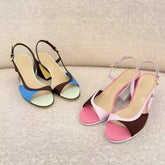 Colorblock slingback block heels on a textured sofa.
