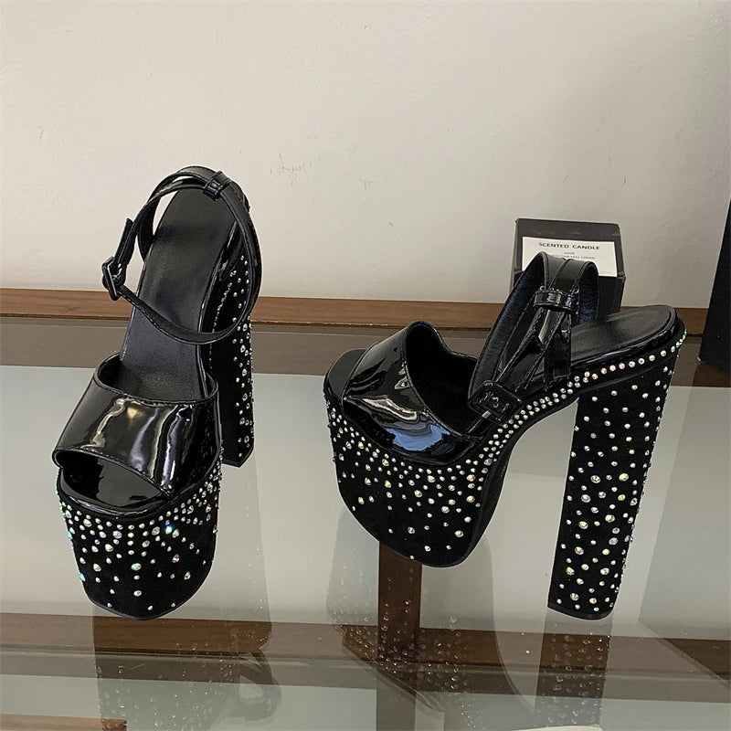 Chunky platform crystal embellished heels on a reflective surface