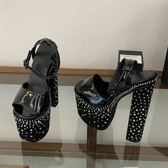 Chunky platform crystal embellished heels on a reflective surface