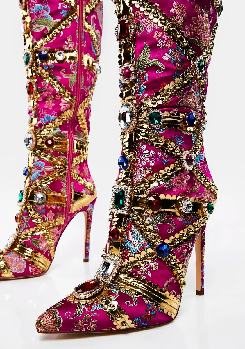 Decorative pink boots with floral patterns and gold embellishments