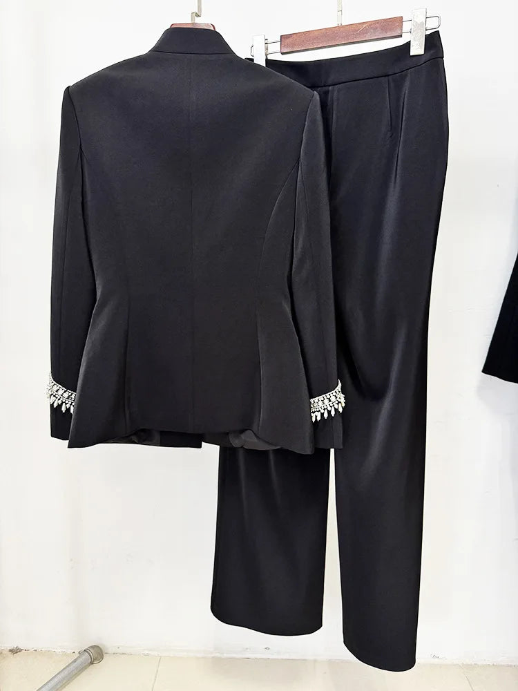 Back view of black embellished stand collar jacket and wide leg pants suit on hangers