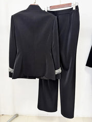 Back view of black embellished stand collar jacket and wide leg pants suit on hangers