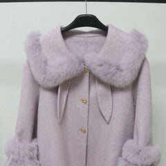 Purple coat with fur collar and cuffs on a hanger against a white background