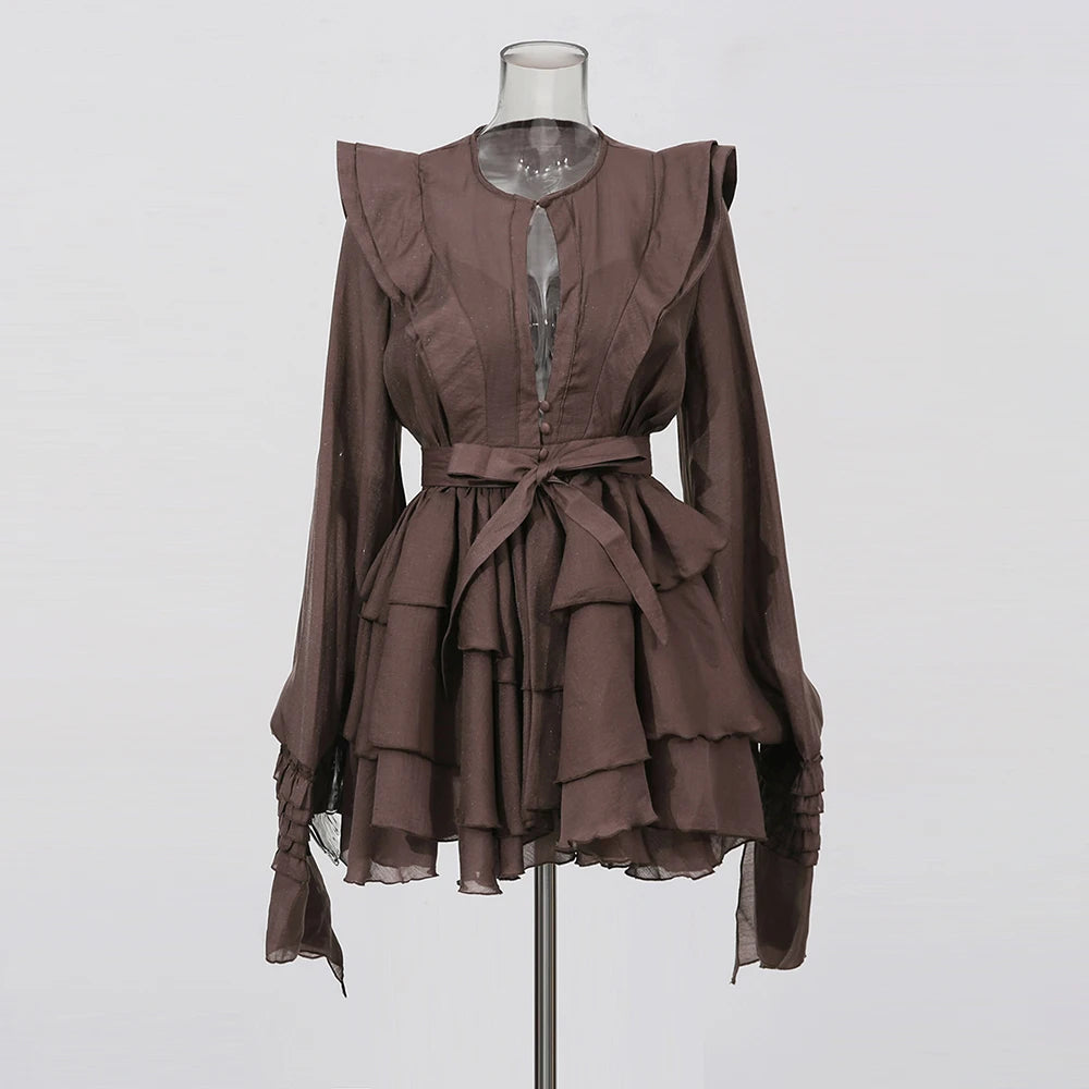 Brown ruffled dress on a mannequin against a white background