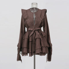 Brown ruffled dress on a mannequin against a white background