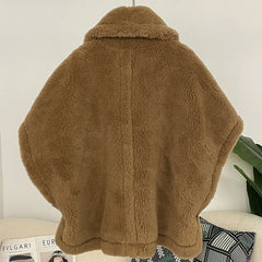 Brown fluffy jacket on a chair with a magazine underneath