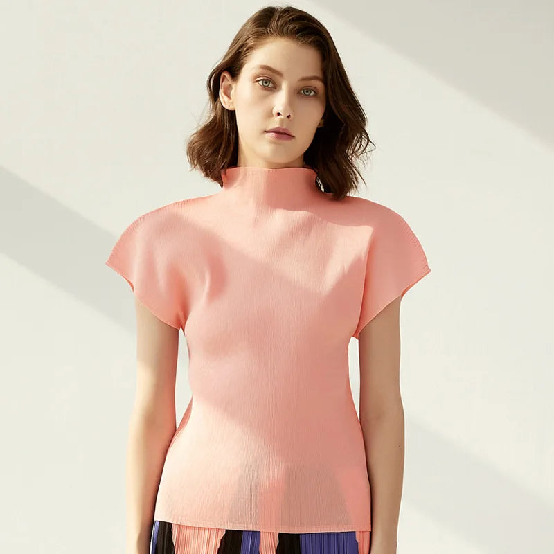 Woman wearing a pink top against a light background