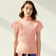 Woman wearing a pink top against a light background