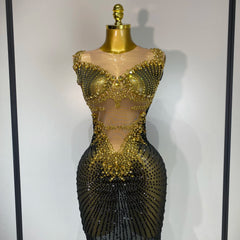 Gold and black beaded dress on a mannequin against a plain background