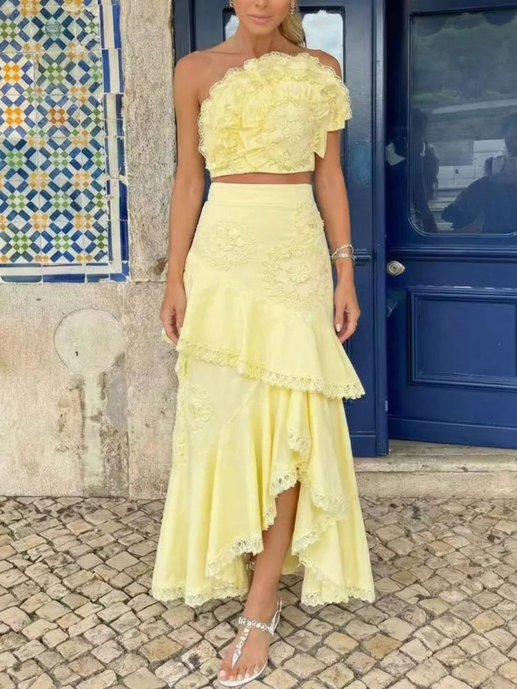 Yellow floral lace one-shoulder crop top with an asymmetric ruffle midi skirt.