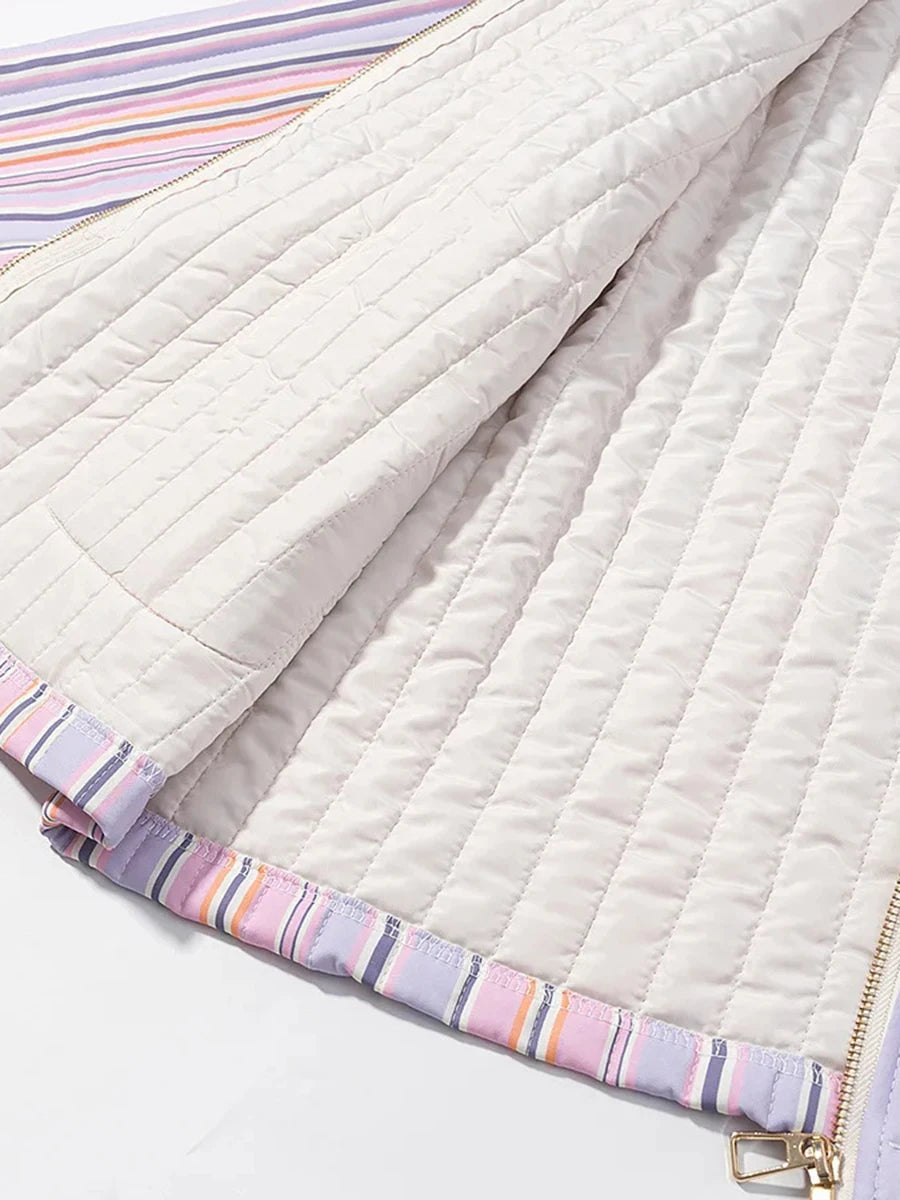 Close-up of a quilted fabric with striped border on a white background
