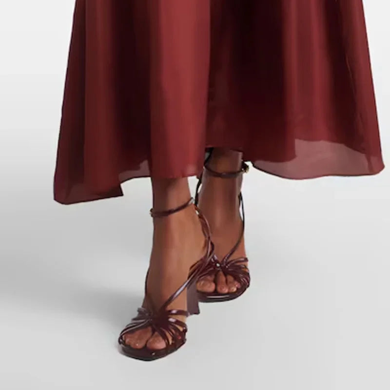 Model wearing strappy wedge heel sandals