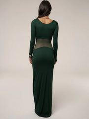Green long-sleeve dress with sheer panels on a plain background