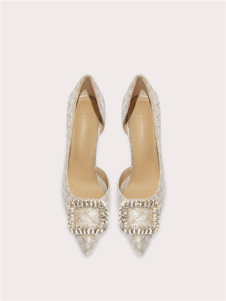 Pair of embellished pointed-toe shoes on a light gray background