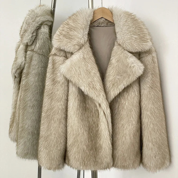 Beige faux fur coat on a hanger against a white background