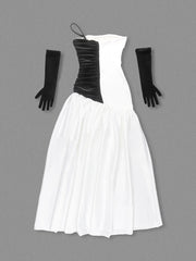 Black and white strapless dress with long black gloves on a gray background
