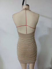 Beige beaded dress on a mannequin with red tape measurements against a white background