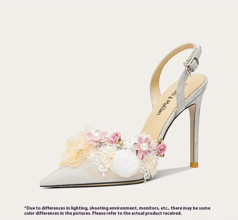 High-heeled shoe with floral decorations on a white background