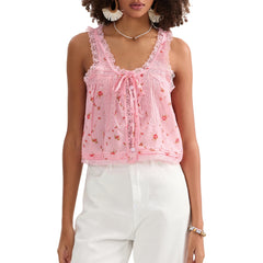 Woman wearing a pink lace top with floral patterns on a white background