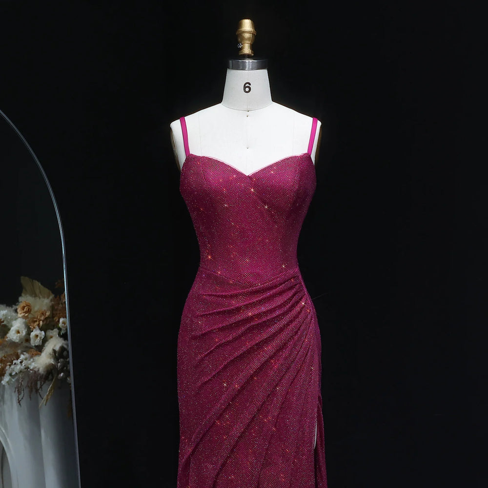 Magenta evening gown on a mannequin against a black background