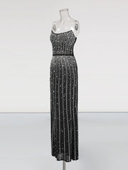 Black sequin evening gown on a mannequin against a white background
