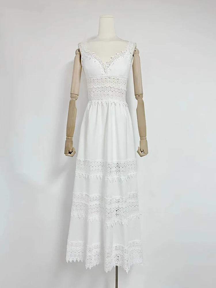 White lace dress on a mannequin against a plain background