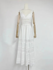 White lace dress on a mannequin against a plain background