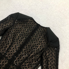 Black sequined jacket on a textured white background