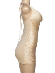 Beige fringe dress on a mannequin against a white background