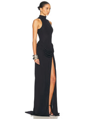 Woman wearing a black evening gown with a high slit - side view