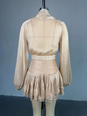 Beige dress on a mannequin against a gray background