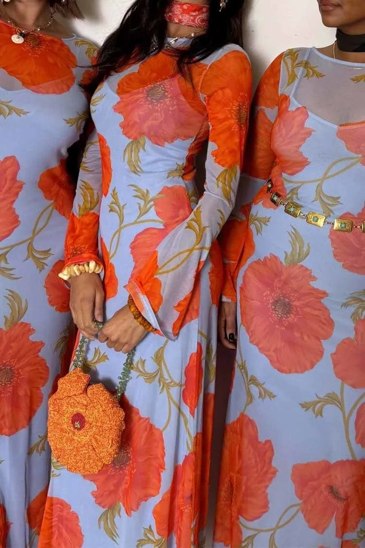 Two women wearing floral dresses with orange and blue colors.
