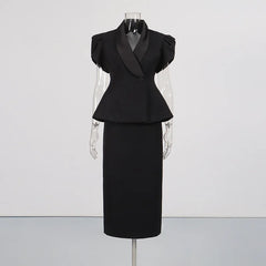 Black peplum blazer with satin lapels and a black midi skirt displayed on a mannequin.